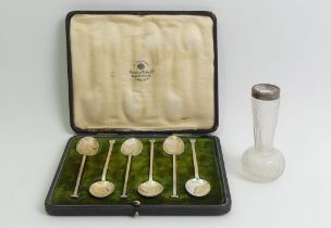 A cased set of Mappin & Webb silver teaspoons, Sheffield 1922, and a silver topped vase.