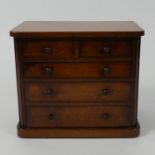 An Edwardian mahogany two over three miniature chest of drawers 20cm x 23cm.