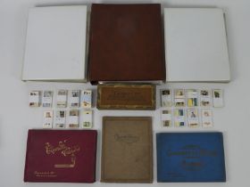 Three folders of vintage cigarette packets together with a quantity of loose cigarette cards.