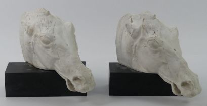A pair of Selene horse busts on slate bases, 25cm x 27cm.