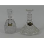 A cut glass ship's decanter with hallmarked silver Scotch label together with one other with a