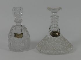 A cut glass ship's decanter with hallmarked silver Scotch label together with one other with a