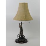 A bronzed figural table lamp in the form of a golfer together with a framed golfing print 63 x 47