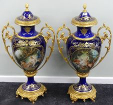 An impressive pair of hand painted porcelain and ormolu mounted vases, probably French. H95cm