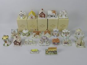 A collection of twenty-one Coalport cottages including boxed examples.