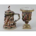 A Naples relief moulded and hand painted urn vase together with a lidded tankard 23cm.