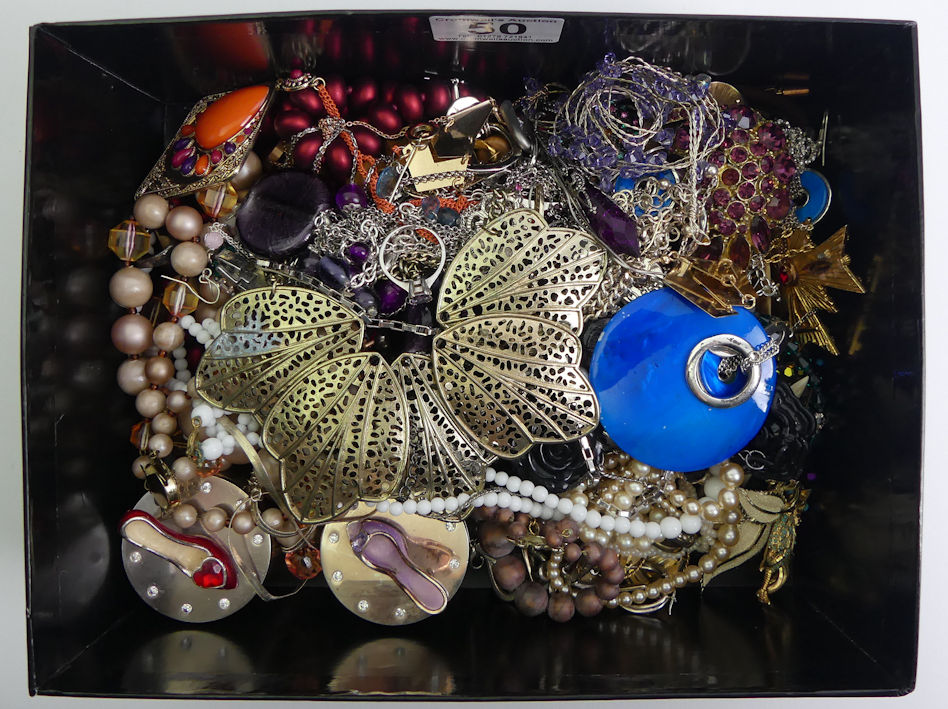 A box of costume jewellery including named pieces and a silver and amethyst ring.