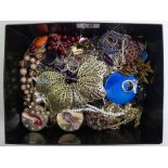 A box of costume jewellery including named pieces and a silver and amethyst ring.