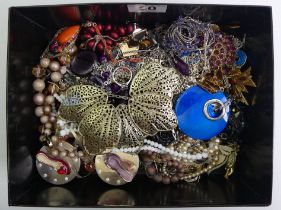 A box of costume jewellery including named pieces and a silver and amethyst ring.
