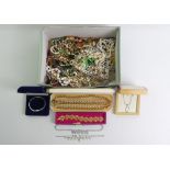 A box of mixed costume jewellery including a silver and diamond pendant and chain.