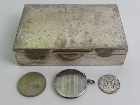 A silver cigarette box, London 1982 and a silver vesta case, Birm. 1923, along with two coins.