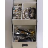 A jewellery box and contents including silver rings and watches.
