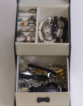 A jewellery box and contents including silver rings and watches.