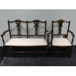 An Edwardian mahogany parlour settee together with a matching elbow chair, 79cm x 106cm.