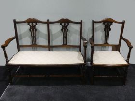 An Edwardian mahogany parlour settee together with a matching elbow chair, 79cm x 106cm.