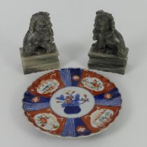 A pair of Chinese temple Lions together with a Japanese Imari porcelain plate, 15cm.