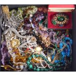 A box of mixed costume jewellery including garnet, amethyst, and malachite necklaces.