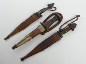 Three vintage African throwing knives with scabbards, blade 18cm.