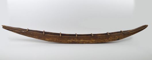 A tribal carved canoe, 138cm.