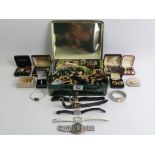 A tin of costume jewellery and watches including a malachite necklace.