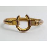 9ct rose and yellow gold (tested) horshoe design bangle, 8.9 grams, 20mm wide.