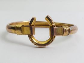 9ct rose and yellow gold (tested) horshoe design bangle, 8.9 grams, 20mm wide.