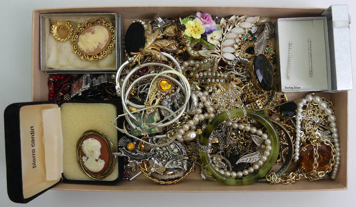 A box of mixed costume jewellery including silver chains.