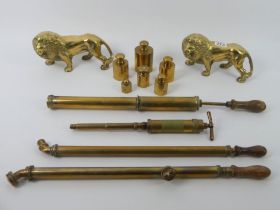 Brassware including a heavy pair of Lions four garden sprayers and a set of brass weights.
