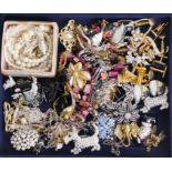 A box of mixed costume jewellery including a silver tree of life necklace and earrings.