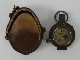 WWI military compass in a leather case, maker H. Hughes & Son, dated 1912.