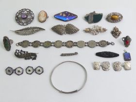 A box of silver jewellery including brooches and enamel cufflinks.