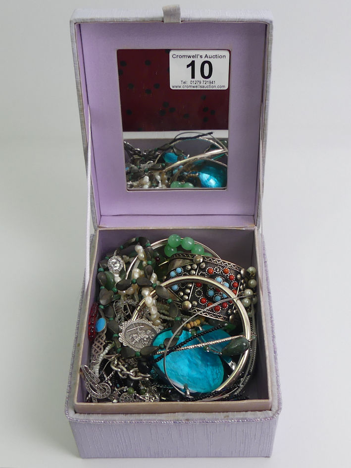 A box of mixed costume jewellery including a silver and marcasite necklace, silver ring and