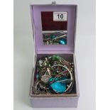 A box of mixed costume jewellery including a silver and marcasite necklace, silver ring and