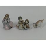 Three Lladro figures, 6226 'Snuggle Up' 5456 'New Playmates' and a dog figure, 16cm.