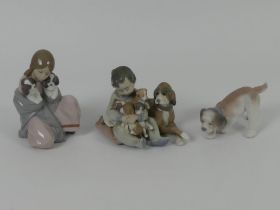 Three Lladro figures, 6226 'Snuggle Up' 5456 'New Playmates' and a dog figure, 16cm.