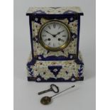 A Victorian china mantel clock striking on a bell, 28cm x 23cm.