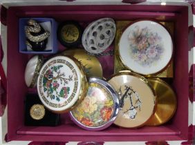 A box of old compacts, two rings and a carved stone egg.
