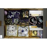 A box of mixed costume jewellery including silver pendants and old watches.