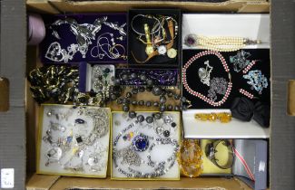 A box of mixed costume jewellery including silver pendants and old watches.