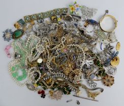 A box of mixed costume jewellery including watches and a cameo brooch.