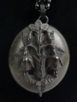 Victorian vulcanite locket pendant on a later black bead necklace, locket 35mm x 50mm.