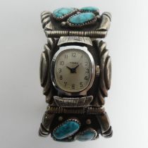 A Native American sterling silver turquoise set watch bangle, 94 grams, 36mm wide.