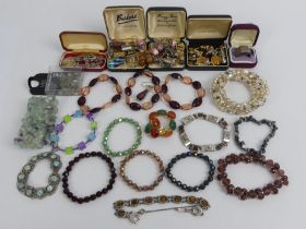 A box of costume jewellery including cufflinks and a sterling silver ring.