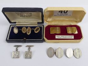 Two pairs of gold on silver cufflinks and two pairs of silver cufflinks.