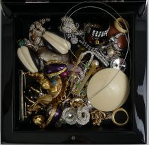 A box of mixed costume jewellery including Trifari and enamel items.