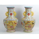 A large pair of Chinese yellow and turquoise ground vases decorated with Flora and Fauna, 50cm.