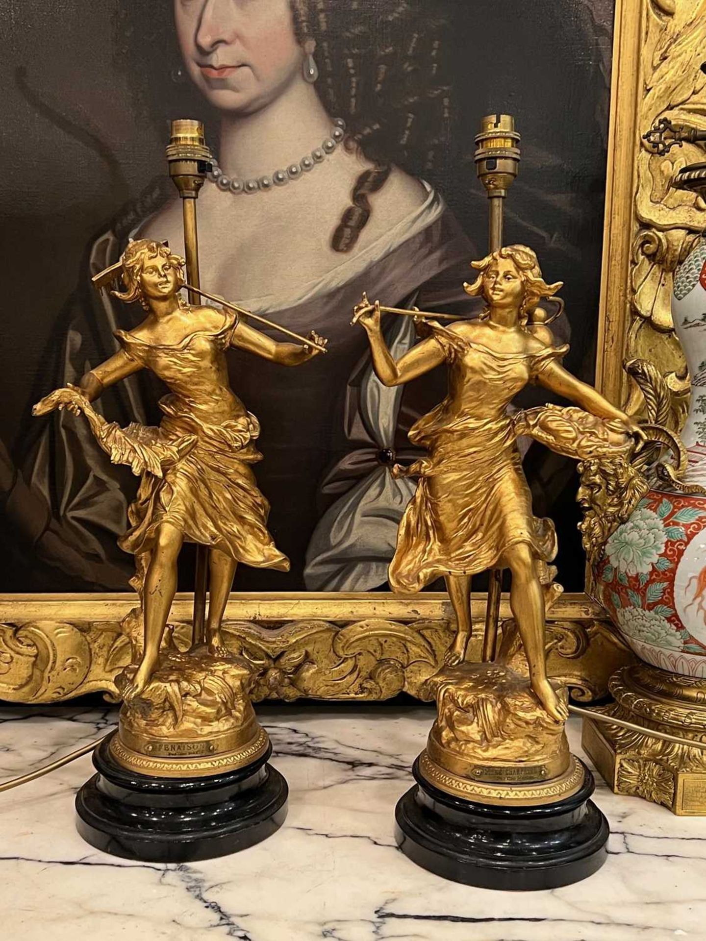 AFTER GEORGES MAXIM (1885-1940): A PAIR OF GILT METAL FIGURAL LAMP BASES