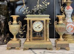 AN EARLY 20TH CENTURY FRENCH GILT BRONZE AND ONYX CLOCK SET