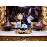 A 19TH CENTURY FRENCH ROCOCO STYLE GILT BRONZE AND PORCELAIN MOUNTED MANTEL CLOCK