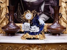 A 19TH CENTURY FRENCH ROCOCO STYLE GILT BRONZE AND PORCELAIN MOUNTED MANTEL CLOCK
